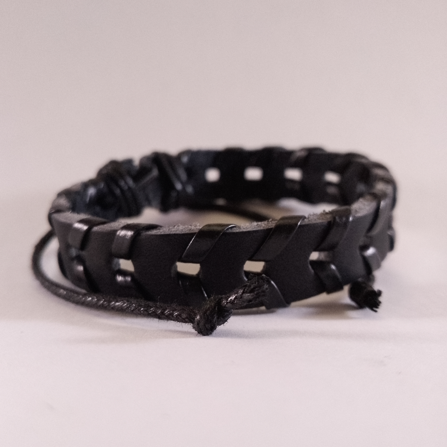 Handcrafted black braided leather bracelet for men & women, stylish Kenyan accessory.