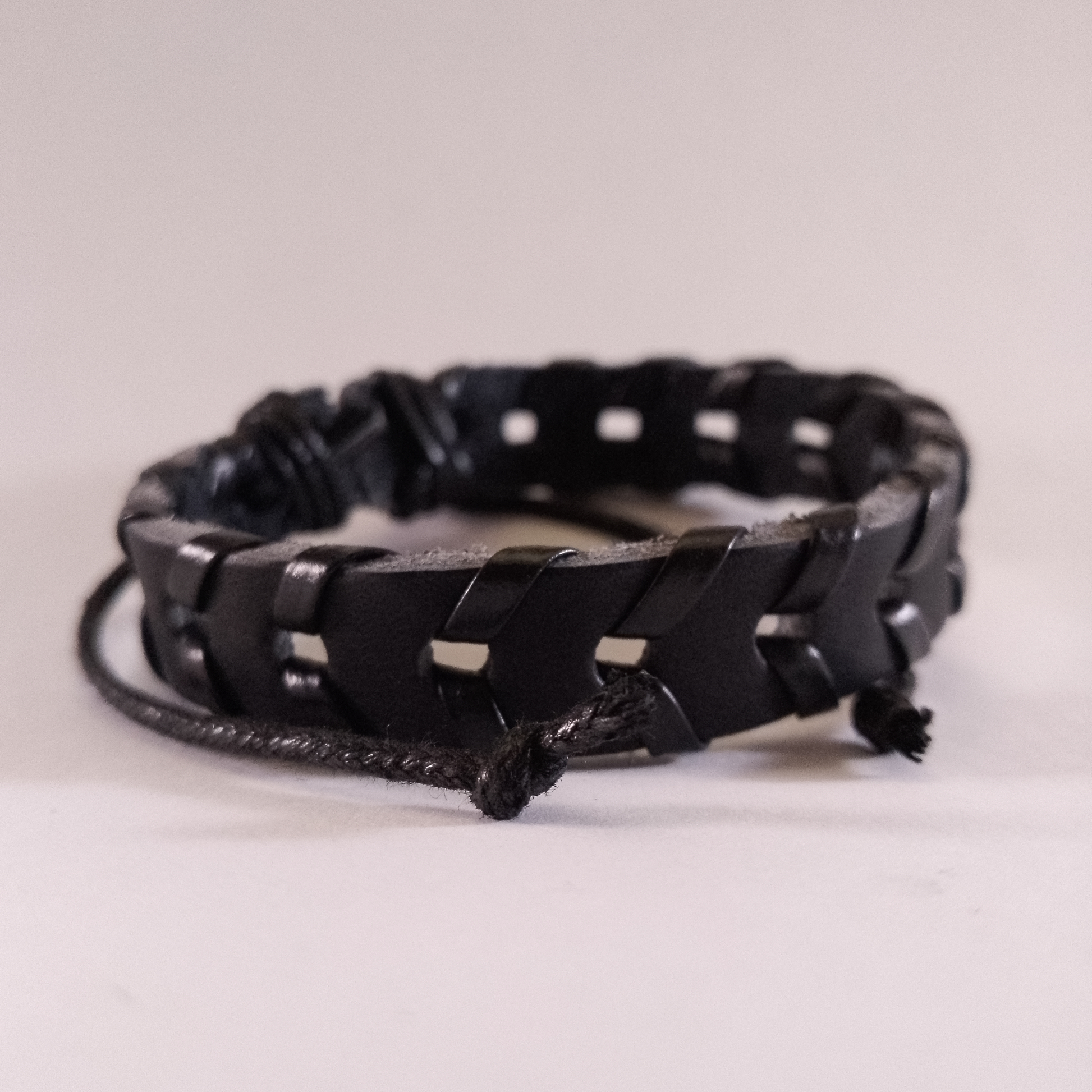 Handcrafted black braided leather bracelet for men & women, stylish Kenyan accessory.